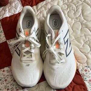 New Balance White Running Sneakers with Navy Logos and Orange Accents